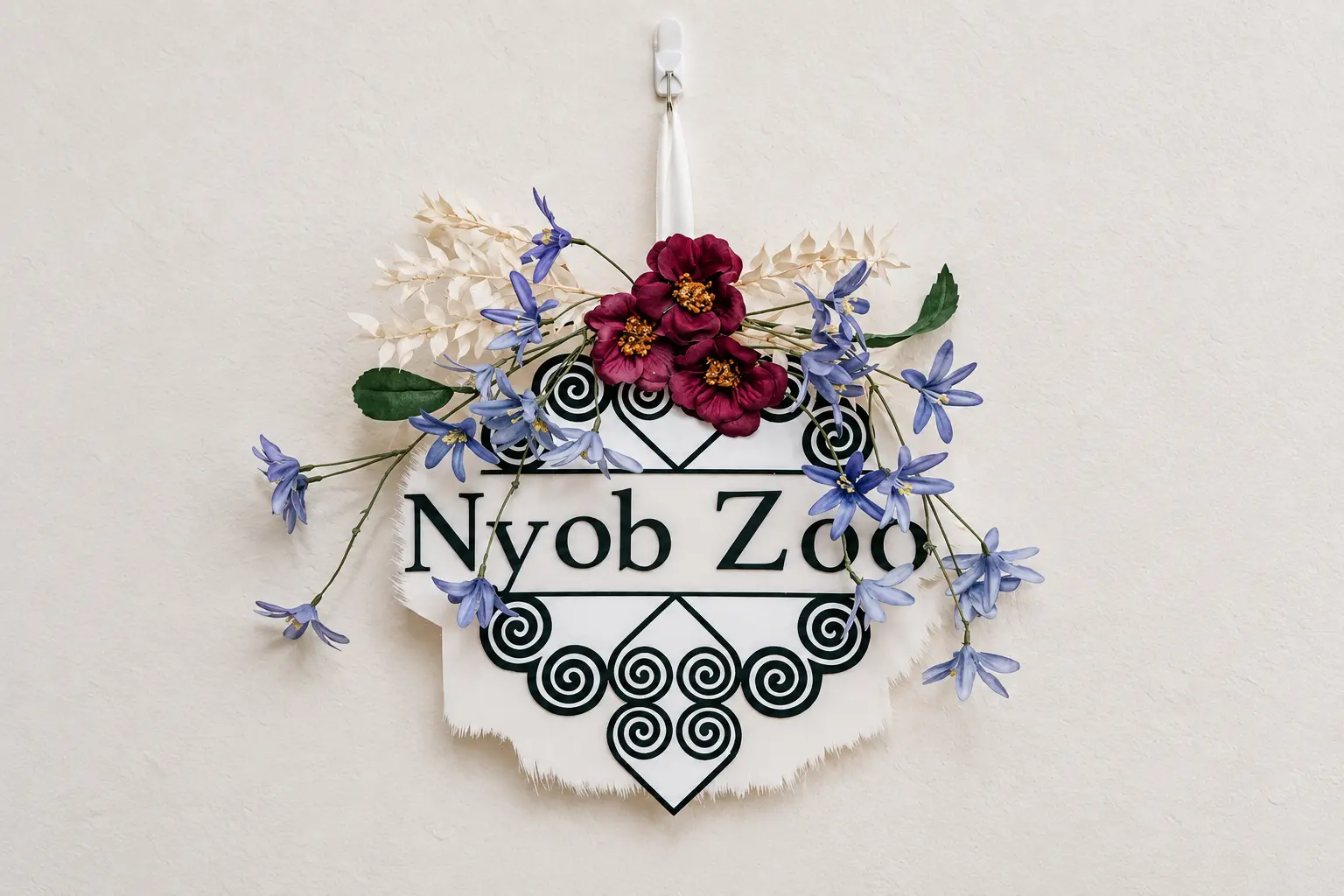 A floral Hmong welcome decoration reading Nyob Zoo