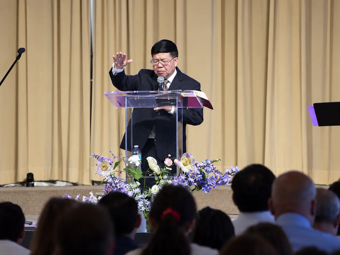A GHAC pastor preaching from the pulpit during a worship service